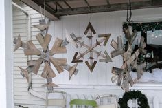 several wooden snowflakes hanging from the side of a house