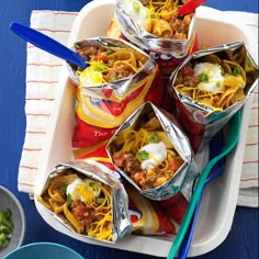 several containers filled with food sitting on top of a table