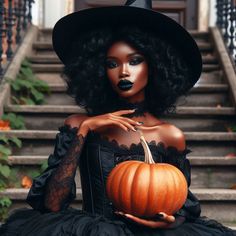 a woman in a black dress and hat with a pumpkin on her hand sitting on the steps