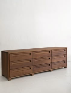 a large wooden dresser sitting on top of a white floor