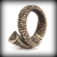 This 3D rams horn statement ring will turn heads no matter who is wearing it. The heavily textured ram horn will wrap your finger in style be you a guy or a gal. It is cast in solid jewelers grade bronze. The carving details are magnified by the alternating bright ridges and dark oxidized recesses. Ladies version is available herehttps://www.etsy.com/listing/242160380/ram-horn-ring-496?ref=shop_home_active_5&ga_search_query=ram%2Bhorn%2BringALTERNATIVE FINISH:https://www.etsy.com/listing/151 Rams Horn, Copper Clay, Horn Ring, Button Studs, Ram Horns, Jewelry Care Instructions, Wrap Ring, Skull Ring, Wrap Rings