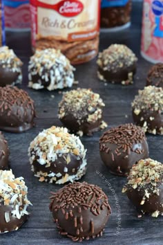 chocolate truffles with coconut sprinkles and crushed nuts on a baking sheet