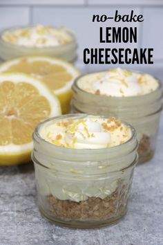 three mason jars filled with dessert sitting on top of a counter next to sliced lemons