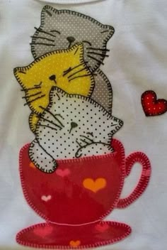 two cats hugging each other in a red cup with hearts on it and one cat is sleeping