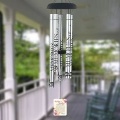 a wind chime hanging from the side of a porch