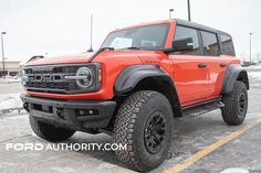 an orange truck parked in a parking lot