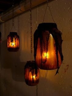 some lights hanging from chains on the wall