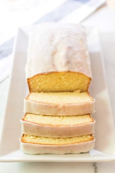 a white plate topped with slices of pound cake covered in frosting and icing