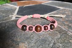 *Please read below for sizing and item details* Beaded hemp bracelet.  Made with soft natural hemp.  This piece is adjustable from 6" at its smallest to 10" at its largest. It's made using a square knot design with a 1mm dusty pink hemp on a 2mm natural colored hemp base. It features five wooden accent beads at the center.  The pink hemp 1mm thickness with a 2mm natural colored hemp core giving it a 3/8" width.  Everyone is different so be sure to measure your wrist/ankle to insure a comfortable Everyone Is Different, Hippie Bracelet, Hemp Bracelet, Hemp Jewelry, Hemp Bracelets, Square Knot, Hippie Bracelets, Knot Design, Boho Bracelet