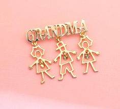 the word grandma is spelled in gold letters on a pink background with two children holding hands