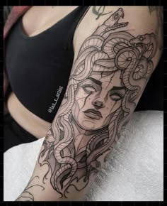 a woman's arm with an intricate tattoo design on the left side of her body