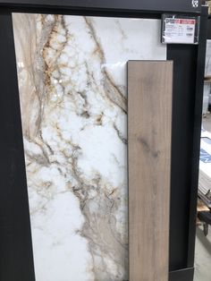 a large marble slab is on display in a store with other items behind it, including a door handle