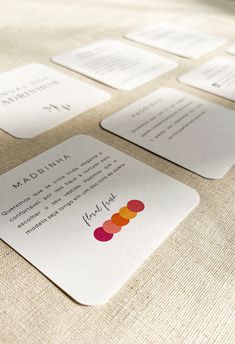 a close up of some business cards on a table with paper circles and words written on them