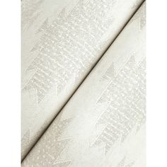 an upholstered fabric with white lace on the bottom and side, in neutral tones