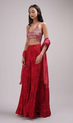 Red halter neck crop top with sequin embroidery. Paired with a rose print sharara and dupatta. - Aza Fashions Fitted Red Sets With Self Design, Red Fitted Sets With Self Design, Red Fitted Self-design Sets, Red Fitted Palazzo Set For Diwali, Fitted Red Palazzo Set For Festive Occasion, Red Palazzo Set With Unstitched Blouse For Diwali, Fitted Red Palazzo Set For Reception, Red Self Design Sharara For Party, Red Palazzo Set With Sheer Dupatta For Party