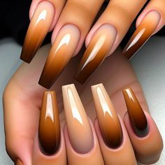 Long, coffin-shaped nails with an ombre gradient from a light caramel brown at the cuticle to a dark chocolate brown at the tips. The transition is smooth and seamless, creating a delicious gradient effect. The nails have a glossy top coat for added shine. Fall Inspired Nails Square, Pedicure Ideas Brown Skin, Nail Designs Brown Color, Gel Ombré Nails, Fall Nails And Toe Nails, Chocolate Brown Fall Nails, Ombre Fall Nail Colors, Brown And Orange Ombre Nails, Short Brown Ombre Nails