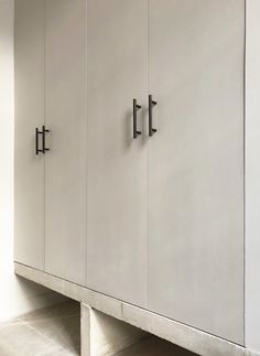 a white cabinet with two black handles on it