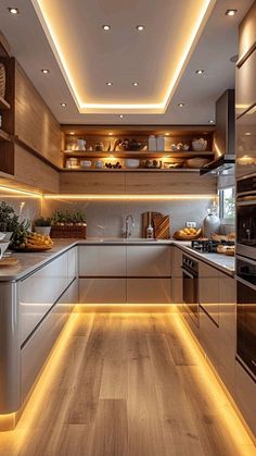 a modern kitchen with wooden floors and white walls, along with recessed lighting on the ceiling