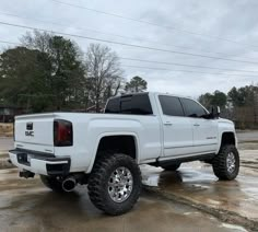 a white truck is parked in the parking lot