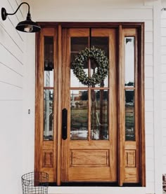 a wooden door with a wreath on it