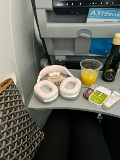 an airplane seat with food and drinks on it