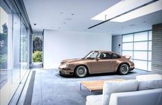 an old porsche sits in the middle of a living room