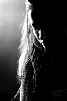 a black and white photo of a woman with long hair