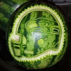 a watermelon carved to look like a helmet with a green face on it