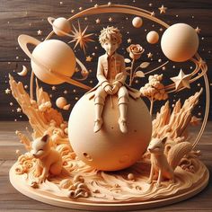 a wooden sculpture of a boy sitting on top of an egg surrounded by stars and planets