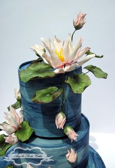 a three tiered cake with water lilies on top