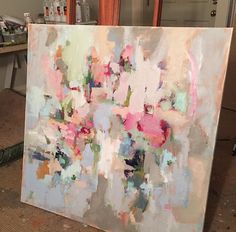 an abstract painting is being worked on in a studio