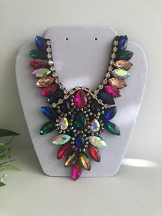 "Beautiful  multicolor statement  necklace  shine and bright for any special occasional  Necklace statement 5.5\" wide. 8\" height with 30\" extender Closure: ribbon tie Adjustable length  Return & exchanges We gladly accept cancellations Request a cancellation within 4 hour of purchase.  We don't accept return or exchanges but please contact us if You have any questions or any problem with your orders Thank you for shopping with us ♥️ Stay safe & healthy" Luxury Multicolor Necklace With Large Beads, Affordable Multicolor Long Necklace, Colorful Costume Jewelry Necklaces For Party, Multicolor Rhinestone Necklace For Party, Multicolor Rhinestone Costume Necklace, Multicolor Rhinestone Costume Necklace For Parties, Multicolor Costume Jewelry Bib Necklace For Party, Oversized Necklace, Bold Statement Necklaces