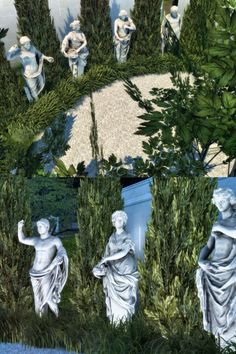 an image of some statues in the grass