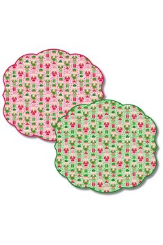 two pink and green placemats sitting next to each other