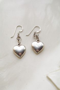 Bursting with Love Puffed Heart Silver Earrings Sterling silver heart earrings!! Dangle earrings. Heart charm earrings. Makes a wonderful sweet sixteen gift! Thank you so much for stopping by! Don't forget to convo me should you have any questions whatsoever! Have a great AND wonderful AND exceptional day!! Please check my other items: http://www.etsy.com/shop/HeartsandCandy facebook: https://www.facebook.com/HeartsandCandy Cute Silver Sterling Heart Earrings, Silver Heart Earrings With Charms, Silver Heart Earrings With Dangling Charms, Silver Heart Dangle Earrings, Vintage Silver Heart Earrings, Silver Heart-shaped Earrings With Dangling Charms, Dainty Silver Earrings, Sterling Silver Heart Earrings, Simple Silver Jewelry