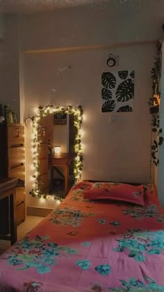 a bedroom with lights on the wall and a bed