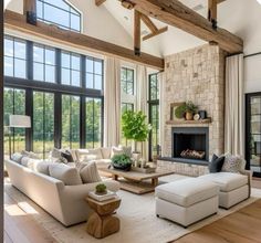 a living room filled with furniture and large windows