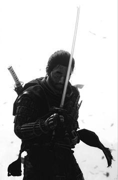 black and white photograph of a man holding two swords