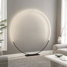 a living room scene with focus on the floor lamp and large circular light in the center