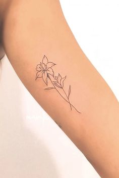 a woman's arm with a flower tattoo on the left side of her arm