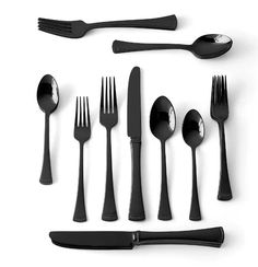 an assortment of black utensils and spoons on a white surface with clipping