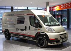 a silver van parked in front of a building