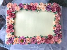 a cake decorated with pink and purple flowers