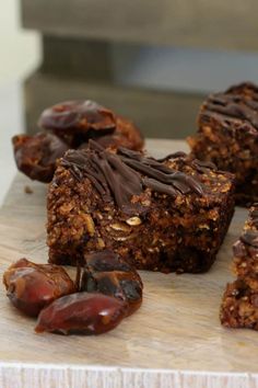 several pieces of food sitting on top of a cutting board next to some raisins