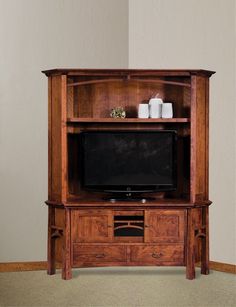 a wooden entertainment center with a flat screen tv