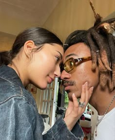 a man with dreadlocks kissing a woman's face