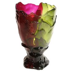 a multicolored glass vase sitting on top of a table