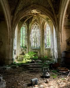 an abandoned church with lots of windows and debris on the ground