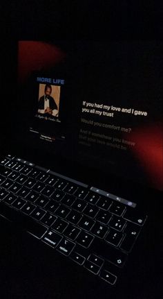 a laptop computer sitting on top of a black desk with a mouse and keyboard in front of it