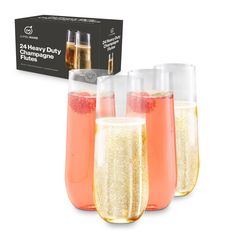 three glasses filled with champagne next to a box